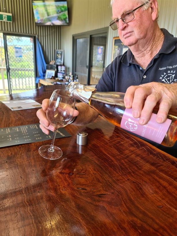 Paul pouring a wine tasting behind the bar