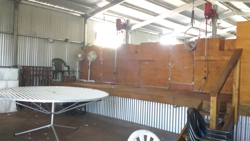 Inside the working shearing shed, set up with a table
